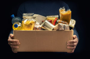 A box of food being held by hands unknown.